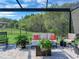 Enjoy this relaxing screened patio with seating and lush landscaping at 31982 Bourneville Ter, Wesley Chapel, FL 33543