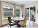 Bright breakfast nook with a round table and four chairs, overlooking the backyard at 31982 Bourneville Ter, Wesley Chapel, FL 33543
