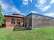 House with screened patio and grassy backyard at 31982 Bourneville Ter, Wesley Chapel, FL 33543