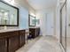 Double vanity bathroom with granite countertops and large shower at 31982 Bourneville Ter, Wesley Chapel, FL 33543