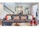 Elegant living room with leather sofa and view of entryway at 31982 Bourneville Ter, Wesley Chapel, FL 33543
