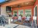 Relaxing outdoor patio with seating area and built-in grill at 31982 Bourneville Ter, Wesley Chapel, FL 33543