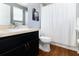 Clean bathroom with dark vanity, toilet, and shower/tub combo at 7016 White Treetop Pl, Riverview, FL 33578