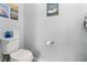 Simple bathroom with white toilet and framed art at 7016 White Treetop Pl, Riverview, FL 33578