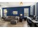 Living room with sectional sofa, home office space, and blue walls at 7016 White Treetop Pl, Riverview, FL 33578