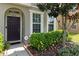 Townhouse front entrance with landscaping and walkway at 7016 White Treetop Pl, Riverview, FL 33578