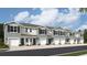 Exterior view of townhomes with attached garages and neutral color palette at 17765 Crescent Moon Loop, Lakewood Ranch, FL 34211