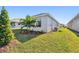 Well-maintained backyard featuring a vibrant lawn, landscaping, and the home's exterior with large windows at 11814 Richmond Trl, Parrish, FL 34219