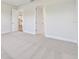 Bedroom featuring neutral carpet and a view to the hallway with doorways at 11814 Richmond Trl, Parrish, FL 34219