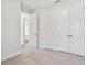 Bedroom featuring neutral carpet, natural light, and a double-door closet at 11814 Richmond Trl, Parrish, FL 34219