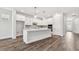 Modern kitchen features white cabinetry, an island with seating, and stainless steel appliances at 11814 Richmond Trl, Parrish, FL 34219