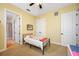 Bright bedroom with a ceiling fan, light yellow walls, and simple decor at 1425 Hillside Landing Dr, Tarpon Springs, FL 34688