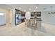 Modern kitchen features stainless steel appliances, a large island with bar seating, and stylish dark cabinetry at 16850 Whisper Elm St, Wimauma, FL 33598