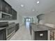 Kitchen featuring stainless steel appliances, granite countertops, and a center island with a sink and barstool seating at 16850 Whisper Elm St, Wimauma, FL 33598