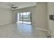 Bright living room featuring a sliding glass door and tile floors at 16850 Whisper Elm St, Wimauma, FL 33598