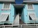 Bright blue building exterior with white stairs and railings at 3730 42Nd S Way # H, St Petersburg, FL 33711