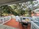 Outdoor deck featuring white railings, painted wood floor, and patio furniture with a lush landscape view at 3730 42Nd S Way # H, St Petersburg, FL 33711