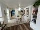 Bright dining area featuring a cozy table, stylish chairs, tile flooring, and charming decor at 3730 42Nd S Way # H, St Petersburg, FL 33711