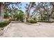 Gated entrance to community, featuring lush landscaping and decorative gatehouse at 3730 42Nd S Way # H, St Petersburg, FL 33711