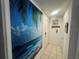 Hallway with beachy decor featuring tile floors, recessed lighting, and a decorative ocean mural at 3730 42Nd S Way # H, St Petersburg, FL 33711
