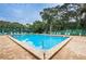 Large community pool with clear blue water, brick pavers, and lounge chairs at 3730 42Nd S Way # H, St Petersburg, FL 33711
