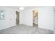 Simple bedroom with gray tile floor and access to a private bathroom at 1843 Oregon Ne Ave, St Petersburg, FL 33703