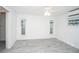 Spacious bedroom with gray tile flooring and dual windows at 1843 Oregon Ne Ave, St Petersburg, FL 33703