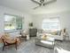 Bright living room with comfy seating, large windows, and a ceiling fan at 1843 Oregon Ne Ave, St Petersburg, FL 33703