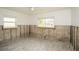 A bedroom under renovation with exposed block walls and new tile flooring at 1843 Oregon Ne Ave, St Petersburg, FL 33703