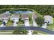 Aerial view of houses on a street near a lake at 25151 Geddy Dr, Land O Lakes, FL 34639