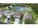 Aerial view of a neighborhood with houses and a pond at 25151 Geddy Dr, Land O Lakes, FL 34639