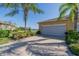 Two-car garage with screen door and view of lake at 1105 Wellington Greens Cir # 1105, Sun City Center, FL 33573