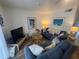Cozy living room with blue sofas, wood floors and beach decor at 3730 42Nd S Way # H, St Petersburg, FL 33711