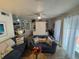 Relaxing living room featuring coastal decor and sliding glass doors at 3730 42Nd S Way # H, St Petersburg, FL 33711