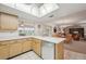 Kitchen with stainless steel appliances, light wood cabinets, and views to the living room at 2102 Hailstone Cir, Sun City Center, FL 33573