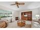 Living room featuring a built-in shelving unit, comfy seating and large windows at 2102 Hailstone Cir, Sun City Center, FL 33573