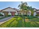 Two-story home with attached garage and landscaping at 16850 Whisper Elm St, Wimauma, FL 33598