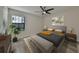 Bright bedroom with plush bed, nightstands, and large window at 16850 Whisper Elm St, Wimauma, FL 33598