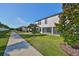 Home exterior showcasing landscaping and walkway at 16850 Whisper Elm St, Wimauma, FL 33598