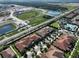 Aerial view of community, showing homes, roads, and undeveloped land at 16850 Whisper Elm St, Wimauma, FL 33598