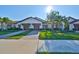 House exterior with two-car garage and landscaping at 16850 Whisper Elm St, Wimauma, FL 33598