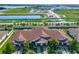 Aerial view of new homes with tile roofs and community amenities at 16850 Whisper Elm St, Wimauma, FL 33598