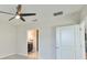 Bedroom with ceiling fan and access to bathroom at 16850 Whisper Elm St, Wimauma, FL 33598