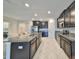 Modern kitchen with stainless steel appliances and granite countertops at 16850 Whisper Elm St, Wimauma, FL 33598