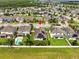 Aerial view showcasing a house with solar panels and a pool at 1100 Multiflora Loop, Lutz, FL 33558