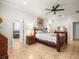 Main bedroom with ensuite bathroom access, king-size bed, and wood furniture at 1100 Multiflora Loop, Lutz, FL 33558