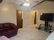 Living room with a leather couch and tiled floors at 11024 111Th Way, Largo, FL 33778