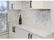 White quartz countertop and hexagon backsplash detail in kitchen at 6291 Bahia Del Mar Cir # 103, St Petersburg, FL 33715