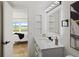 Bathroom with a view, white vanity, and black accents at 6291 Bahia Del Mar Cir # 103, St Petersburg, FL 33715