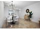 Bright dining room with a modern chandelier and seating for four at 6291 Bahia Del Mar Cir # 103, St Petersburg, FL 33715